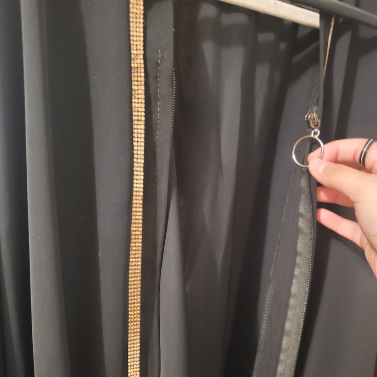 A zipper of my abaya, showing a sliding motion.