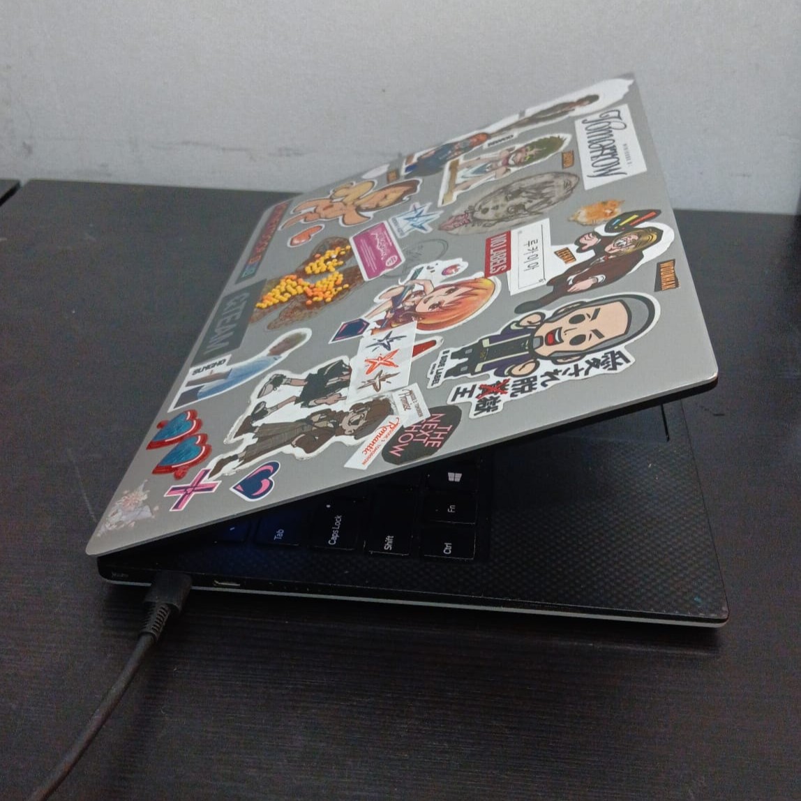 An open laptop whose lid movement and keyboard afford typing and tapping interactions.