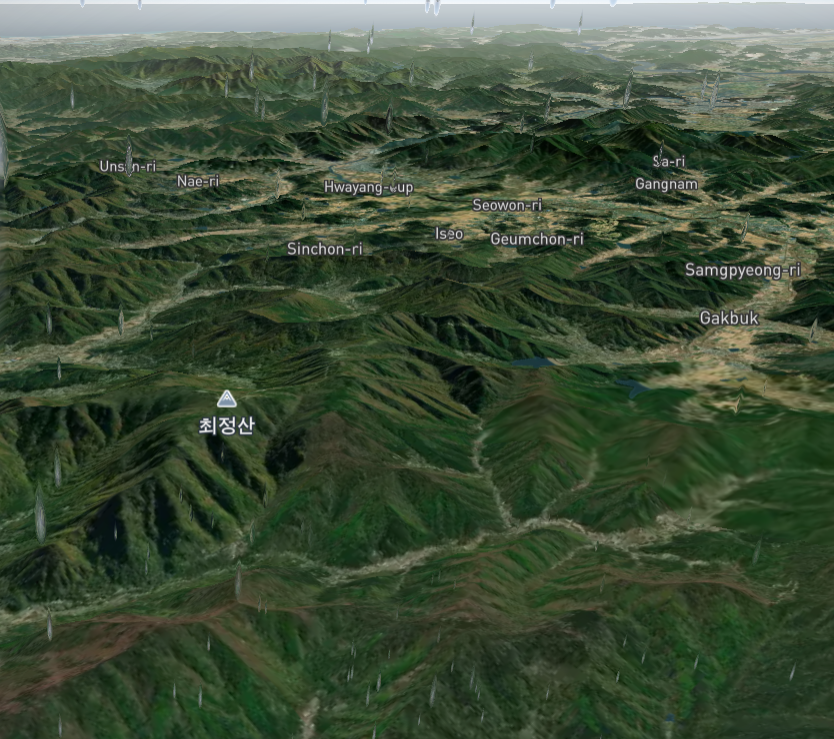 A realistic overview of some hills near a small town in South Korea.